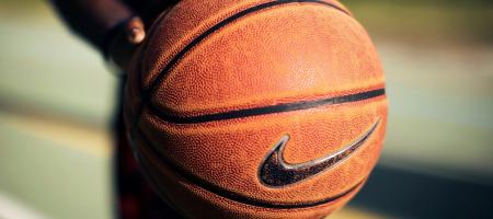 person holding brown Nike basketball